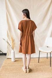 Copper jersey dress with cross-over front and drop shoulder – MAS Montréal, SS27