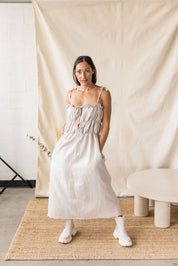 Beige linen-cotton dress with tiered gathering and front ties – MAS Montréal, SS27