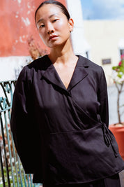 Skelling Blouse in Black (Carbon) wrap-front lyocell blouse, worn - MAS Montréal